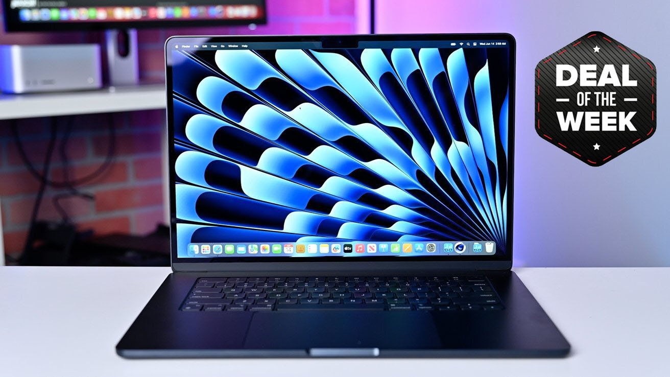 Midnight MacBook Air 15-inch on a table displaying a colorful wallpaper, 'Deal of the Week' badge in the background, with ambient colored lighting.